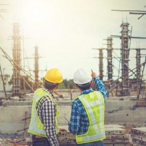 Two young man architect on a building construction site